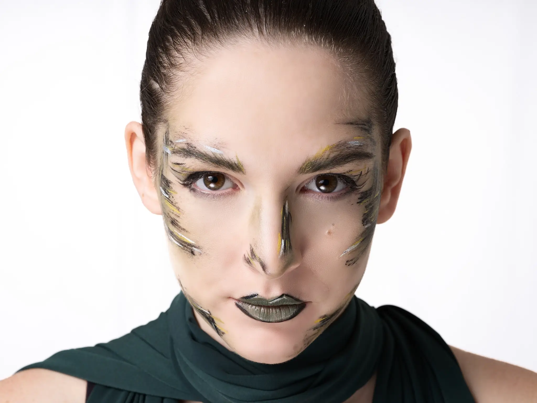 Beauty studio portrait of brunette model with creative makeup