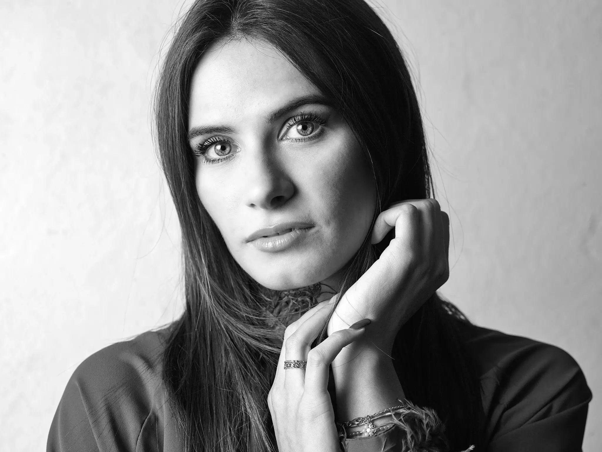 Studio black and white portrait of brunette model on white background