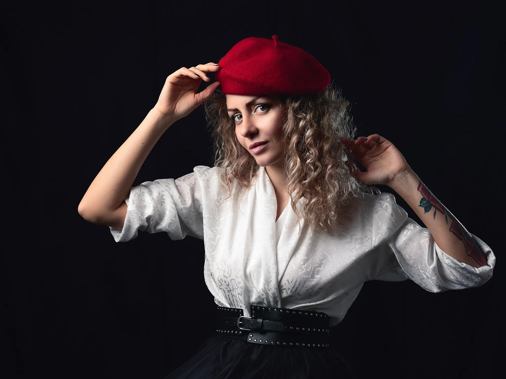 Studio portrait of blonde model on dark background