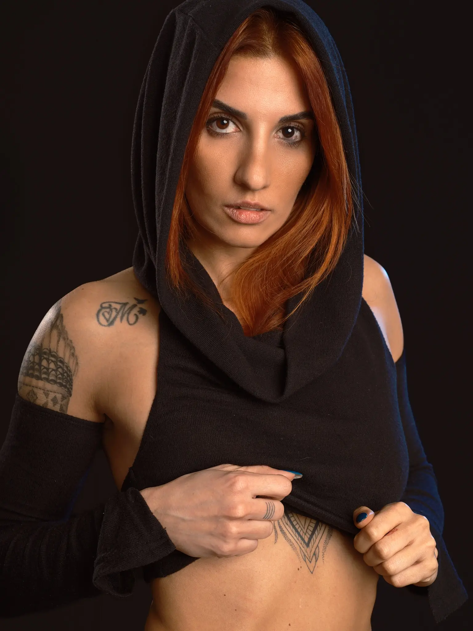 Studio portrait of model with dark hood